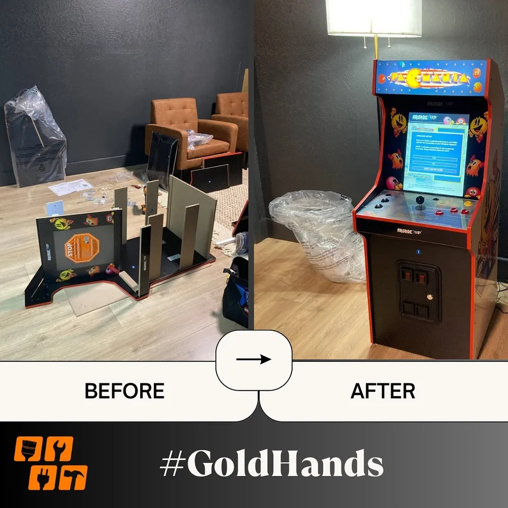 An arcade machine being assembled, with parts on the floor and finished machine