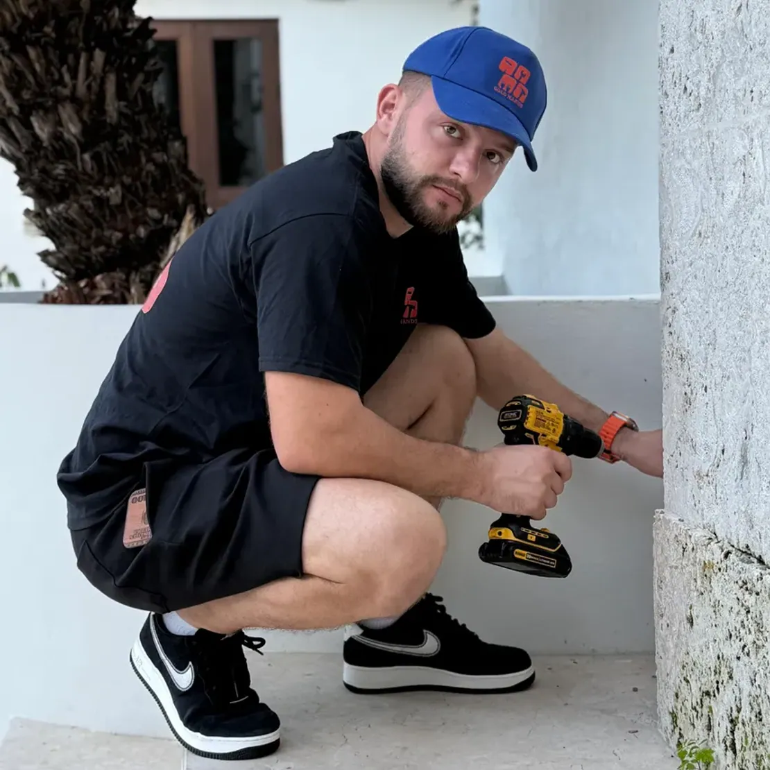Gold Hands technician drilling an exterior wall