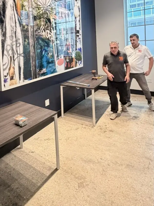 Arsen and Slava of Gold Hands at an office artwork installation