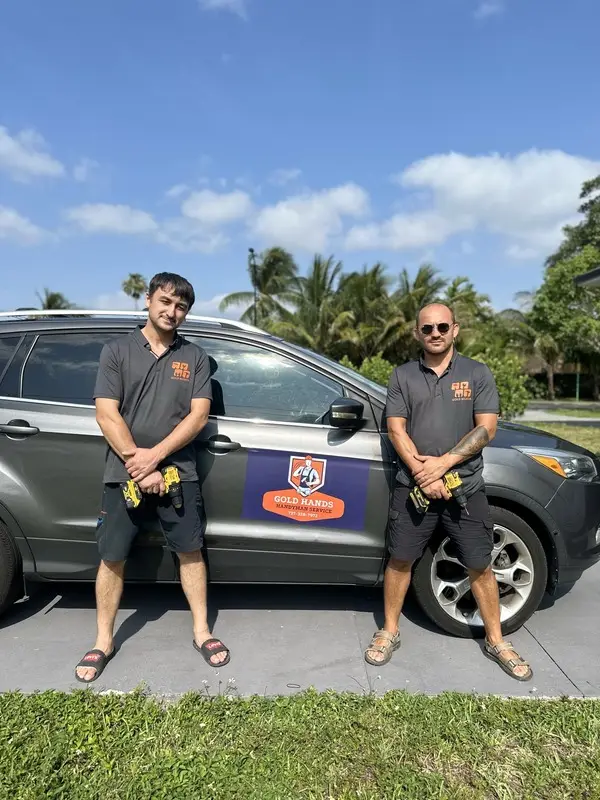 Gold Hands team with a company car